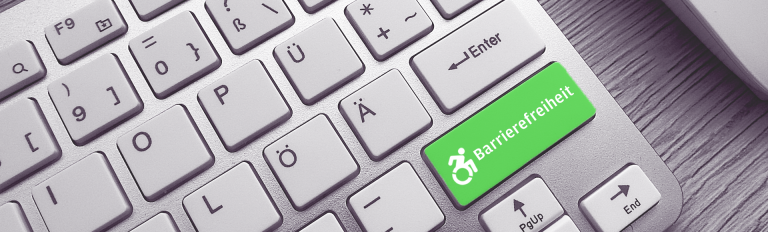 Tastatur mit Sondertaste "Barrierefreiheit" in grün.